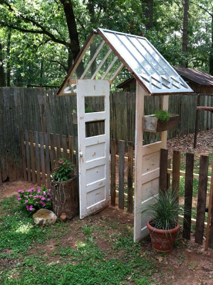 Reused Windows and Doors make a Gate #olddooroutdoordecor #olddoorgarden #decorhomeideas